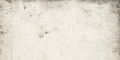 © Sabir - A blank vintage design features a rough old paper texture blended with a grimy white stone wall pattern to create a weathered grunge surface for use as a textured marble or cement background
