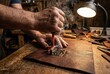 © Stitch - Artisan hands pressing hot branding iron stamp onto piece of leather