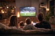 © andyaziz6 - Family of four sitting on a plush fabric sofa in a cozy living room watching a football game on a flat-screen television