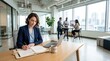 © Matt - Businesswoman writing in planner at desk in coworking office