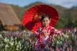 © geargodz - preschool child girl in yukata (kimono dress) holding umbrella with angelonia flower blooming in garden