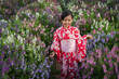 © geargodz - preschool child girl in yukata (kimono dress) with angelonia flower blooming in garden