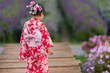 © geargodz - preschool child girl in yukata (kimono dress) with flower blooming in garden