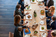 © Rawpixel.com - Business lunch with diverse professionals.