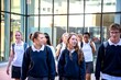 © Rawpixel.com - Students walking outside school building.