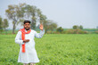 © PRASANNAPIX - young indian farmer standing at green agricultural field