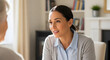 © BornHappy - Close up of smiling lady engaging in meaningful talk with blurred person in cozy indoor setting