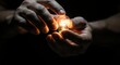 © Salman - Hands holding small glowing light bulb, idea and innovation concept, warm light in darkness