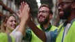 © Murtaza - Team Celebrating Success in Warehouse Environment