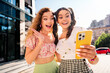 © deagreez - Playful city friends selfie moment full of joy fashion and travel on a sunny street day