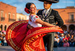 © elita888.element - Mexican couple dancing traditional folk dance in colorful attire, concept of Cinco de Mayo