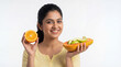 © Niks Ads - young indian woman holding fruits standing on white background
