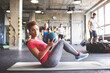 © Westend61 - Group of young people exercising in gym