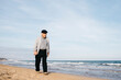 © Westend61 - Senior man strolling on the beach in spring