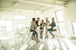 © Westend61 - Group of creative professionals having a meeting in a bright office, discussing new solutions