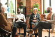 © DC Studio - African american guy having mental health discussion with caucasian people in brick wall room. Multiethnic group sitting in circle and talking about addiction recovery during therapy session.