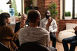 © DC Studio - Person sharing achievement with group of people at aa meeting, sitting in circle. Man at therapy session talking about alcohol addiction with rehab patients and psychotherapist.