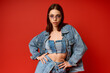 © Bliss - Stylish young woman showcases denim fashion in a vibrant studio setting