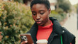 © Andrii Nekrasov - Woman Using Phone on Street in Red Turtleneck
