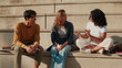 © Andrii Nekrasov - Friends Sharing Conversation On Outdoor College Steps