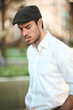 © Teodor Lazarev - Young man smoking cigarette wearing black flat cap