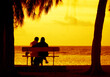 © Rechitan Sorin - Silhouette seniors couple waiting for the colourfull sunset on the bench near the Indian Ocean, Mauritius, Africa