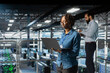 © DC Studio - Woman engineer on data center industrial platform performing system maintenance, high tech. IT professional using laptop to do upgrades, resolving bugs and enhancing infrastructure stability.