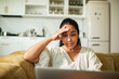 © Marko Geber - Stressed woman looking at laptop in home kitchen