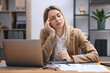 © New Africa - Woman feeling fatigue at wooden desk in office