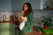 © wifesun - Pregnant woman sipping a fresh green smoothie in a bright home kitchen, surrounded by fruits and vegetables, prioritizing prenatal nutrition and wholesome self-care during pregnancy