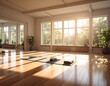 © Pesen - A sun-drenched, spacious studio with large windows overlooking a lush green landscape. Yoga mats and props rest on a wood floor