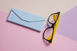 © VI-stock studio - Eyeglasses with case on pastel colored background