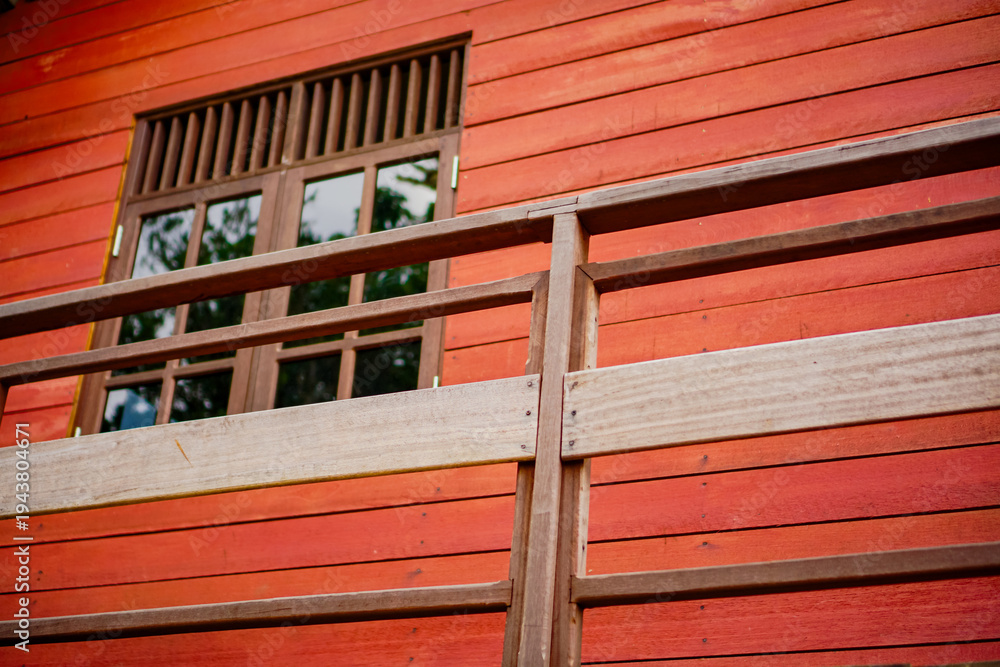 Texwin Rustic Red Building Vibrant red wooden house exterior featuring a detailed window and ...