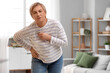 © Pixel-Shot - Mature woman with pills experiencing menopause at home