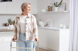 © Pixel-Shot - Mature woman with walker in kitchen
