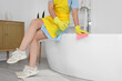 © Pixel-Shot - Housewife cleaning bathtub in room