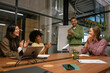 © Westend61 - Colleagues applauding during business presentation at office meeting