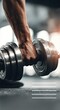 © Alexander LW - A close-up shot of a hand lifting a dumbbell in a modern sports setting. Banner
