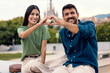 © Westend61 - Smiling couple forming heart shape with hands outdoors in city park