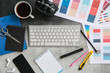 © Pixel-Shot - Workplace of graphic designer with keyboard, color charts and coffee on grey grunge table