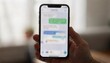 © Justlight - Medium shot focused on a smartphone showing an SMS preview of a payment reminder with hand and surroundings gently out of focus.
