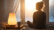 © Sergey - person sitting in front of bright light therapy lamp during winter morning, calm indoor scene, mental wellness concept