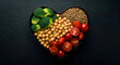 © Shah Zain - A heart-shaped plate filled with broccoli, chickpeas, lentils, and halved tomatoes on a dark surface.