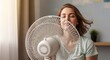© PNG&Background Image - Young Woman Cooling Off in Front of Electric Fan During Summer Heatwave