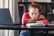© Tatyana Gladskih - Sad and tired student girl looking on laptop and notebook