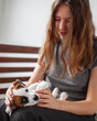 © Tatyana Gladskih - Woman Playing with cute Puppy Dog at home