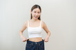 © KMPZZZ - Shape slender, thin waist, slim fit asian young woman, showing body shape her weight loss, happy wearing in big, large or oversize jeans, excess lose by diet and exercise. Healthy lifestyle concept