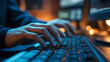 © Heru Wahyudi - Close up of programmer hands typing on computer keyboard in dark room with cinematic blue lighting
