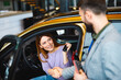 © djile - Female customer shaking hands with salesman after buying new car