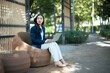 © Parichat - Young businesswoman using laptop working outdoors in stylish cafe